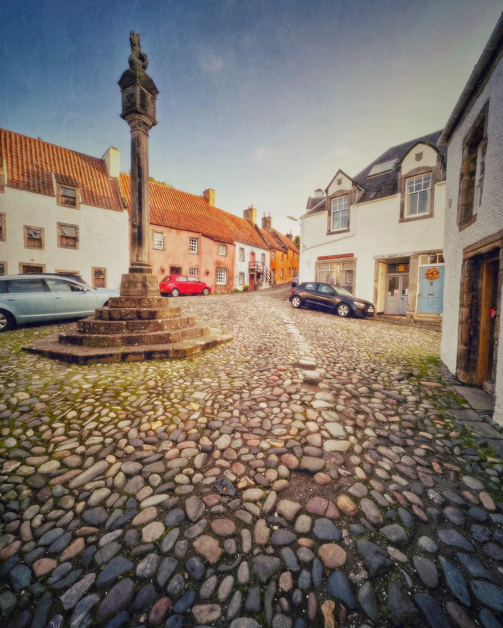 The cobbled village center of Culross in the Kingdom of Fife, surrounded by old whitewashed and warm-colored buildings